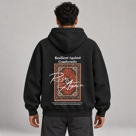 Model wearing KIFL Rise Again oversized hoodie in black – straight back view of carpet print