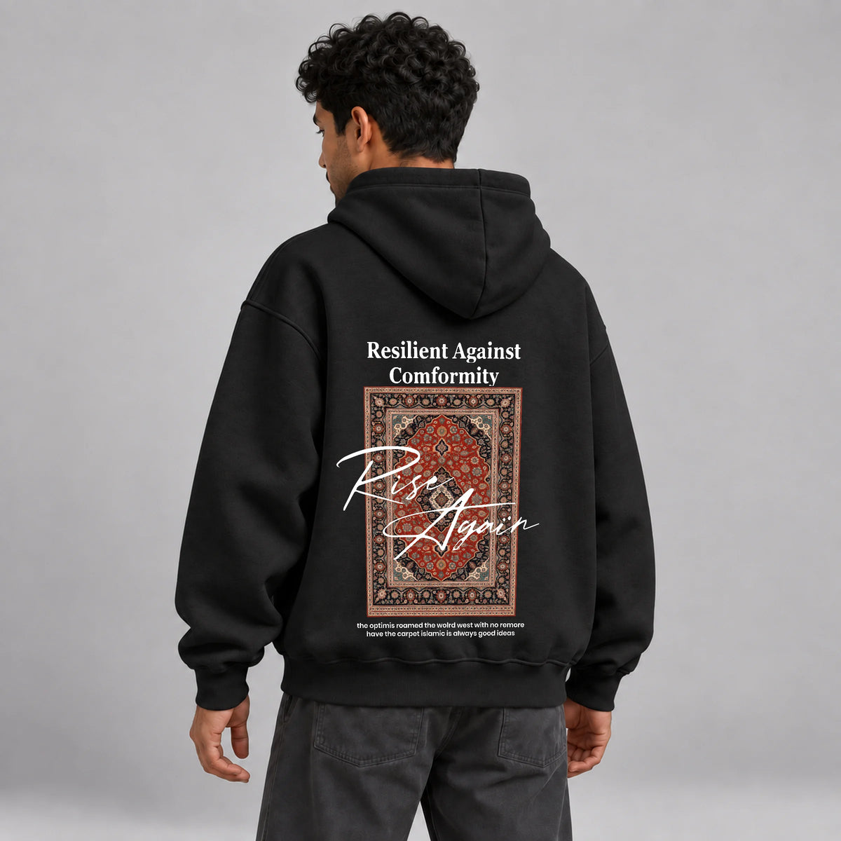 Model wearing KIFL Rise Again oversized black hoodie – three-quarter back view