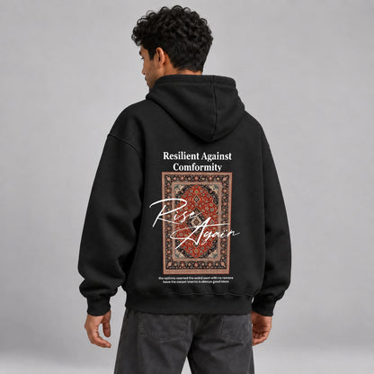 Model wearing KIFL Rise Again oversized black hoodie – three-quarter back view