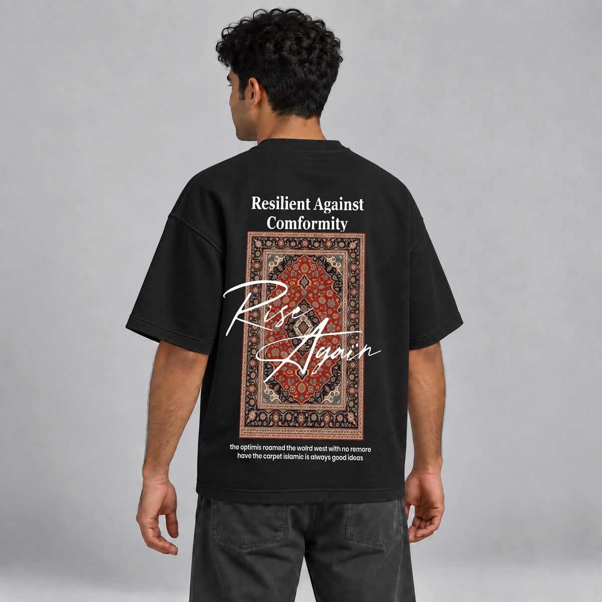 Model wearing KIFL Rise Again oversized black tee – three-quarter back view