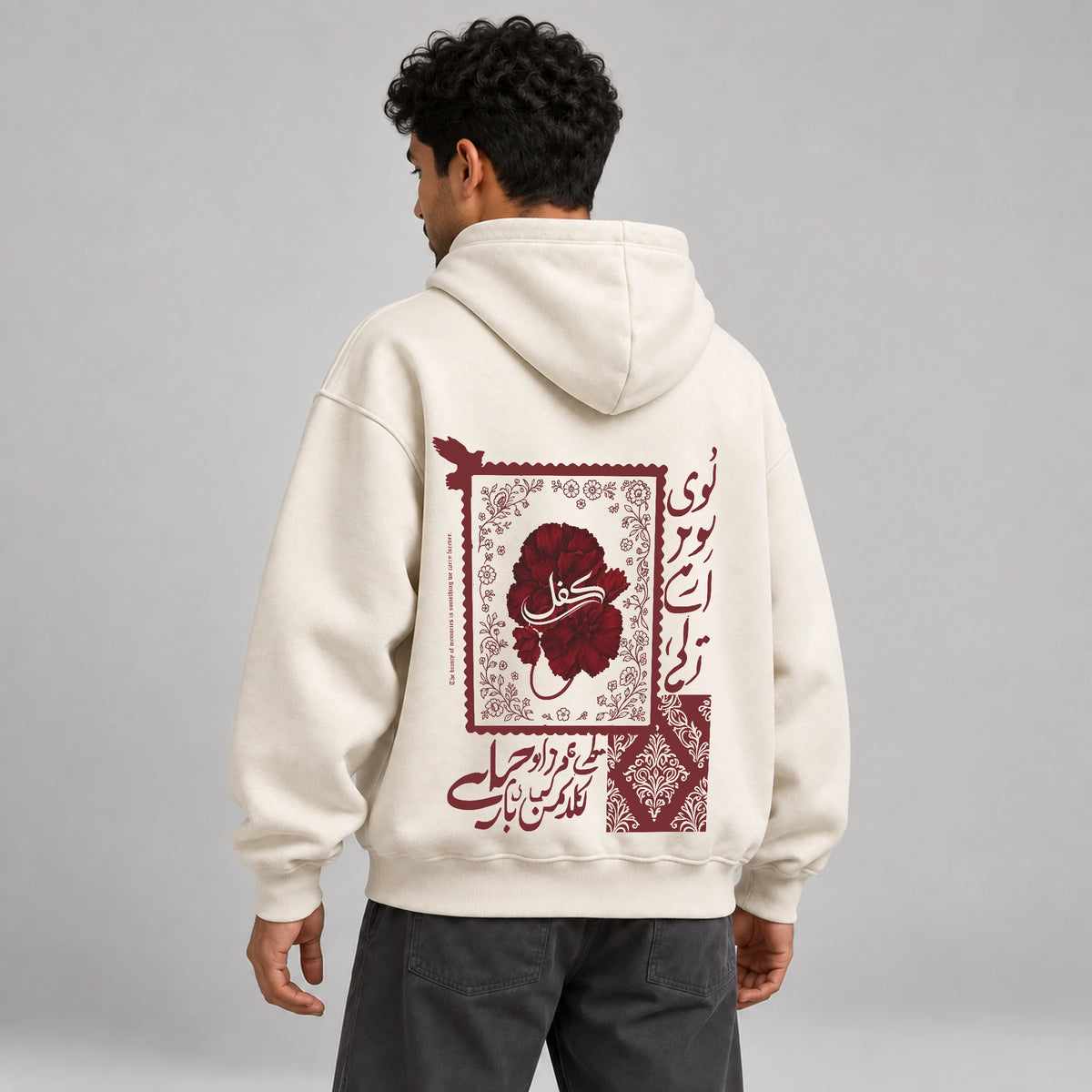 Model wearing KIFL Urdu Floral oversized hoodie – three-quarter back view