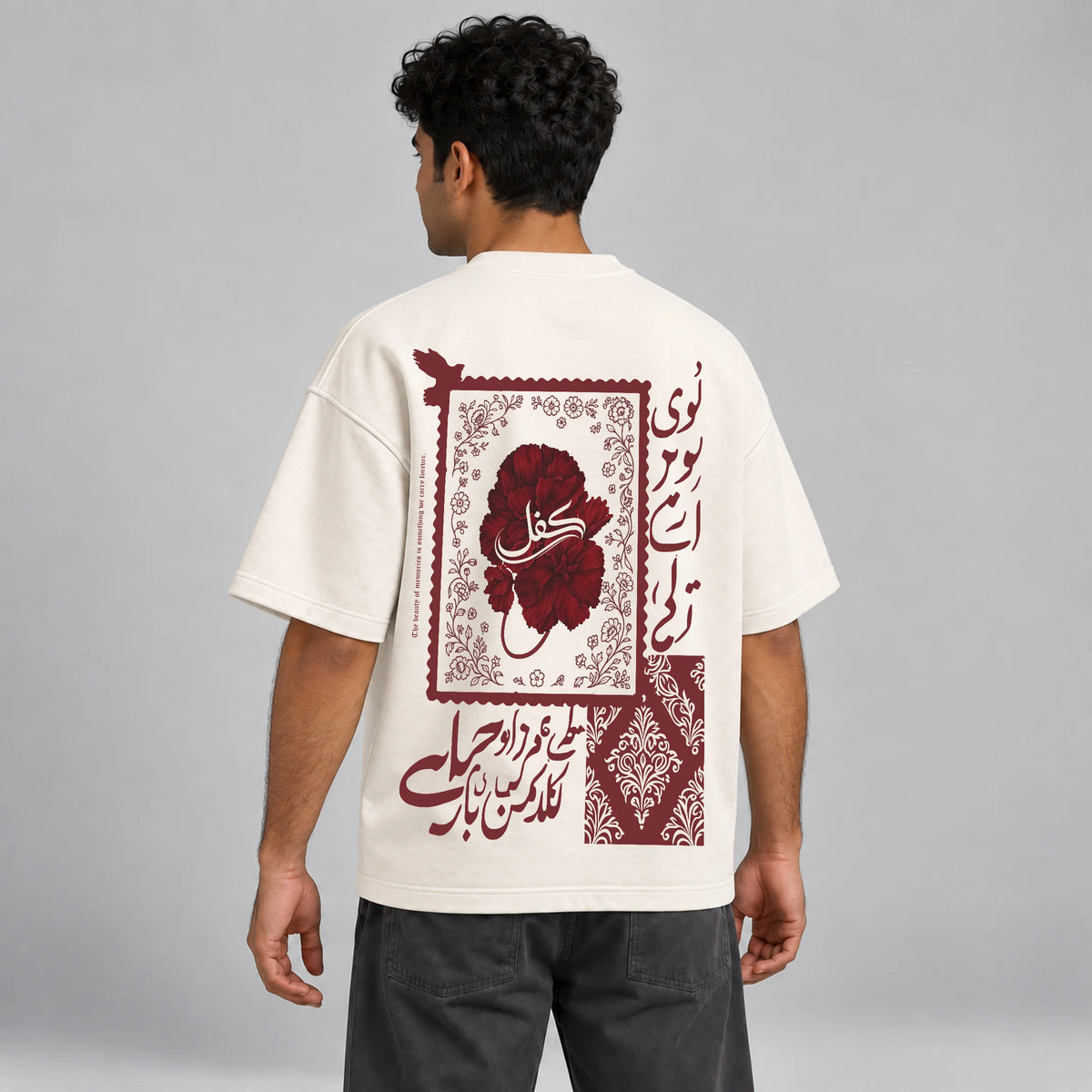 Model wearing KIFL Urdu Floral oversized tee – three-quarter back view